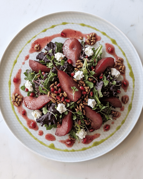 Red Wine Poached Pear Salad with Pomegranate Vinaigrette, Candied Sunflower & Pomegranate Seeds, Goat Cheese