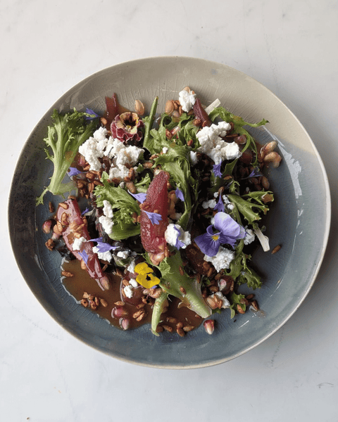 Red Wine Poached Pear Salad with Heritage Green Salad, Pomegranate Vinaigrette, Candied Sunflower Pomegranate Seeds and Goat cheese (V, GF)