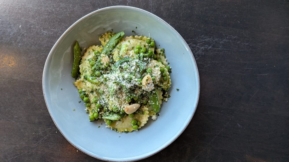 Spring Spinach and Cheese Agnolotti (V) Kale Pesto I Sugar Snap Peas I Green Peas I Charred Green Onion I Confit Garlic